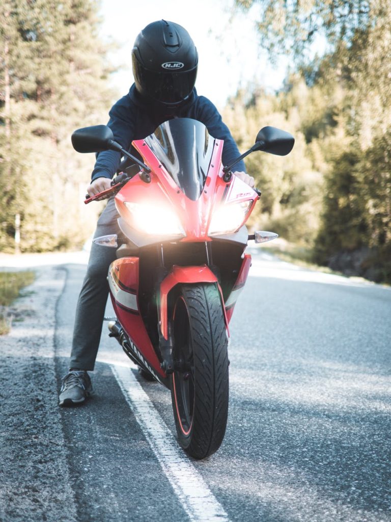 person riding red sports bike