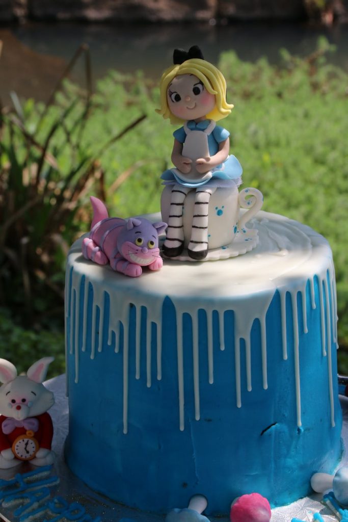 an alice in the wonderland theme birthday cake